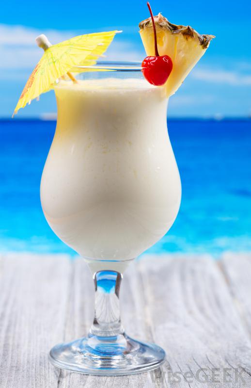 drink-with-pineapple-cherry-and-cocktail-umbrella-near-ocean